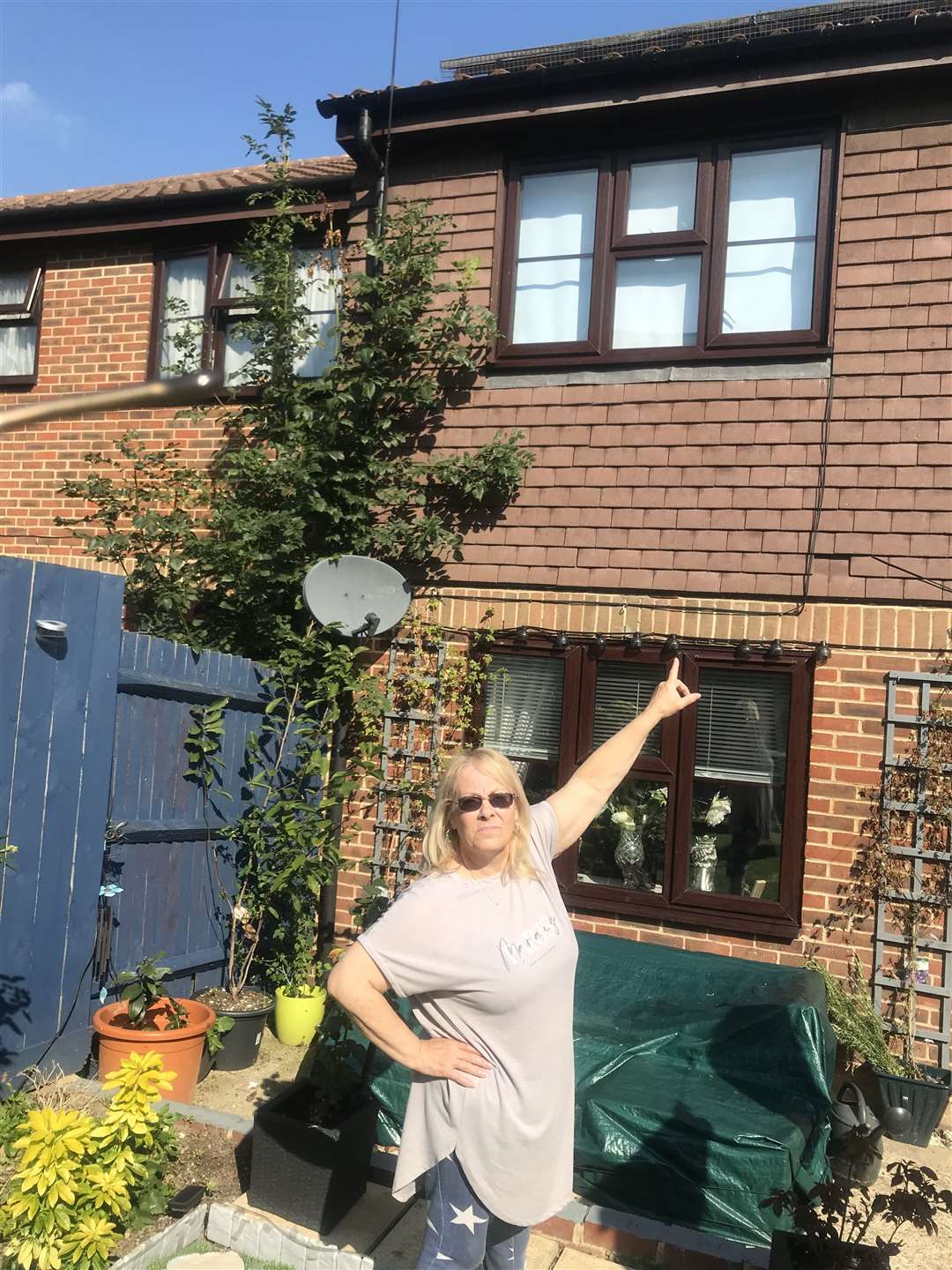 Pauline Saker outside her bird-infested home